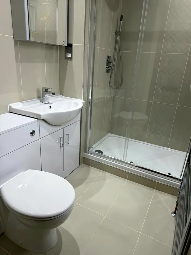 Complete bathroom with toilet, vanity unit and shower